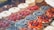 An assortment of fresh fruit cakes displayed on a rustic wooden table.