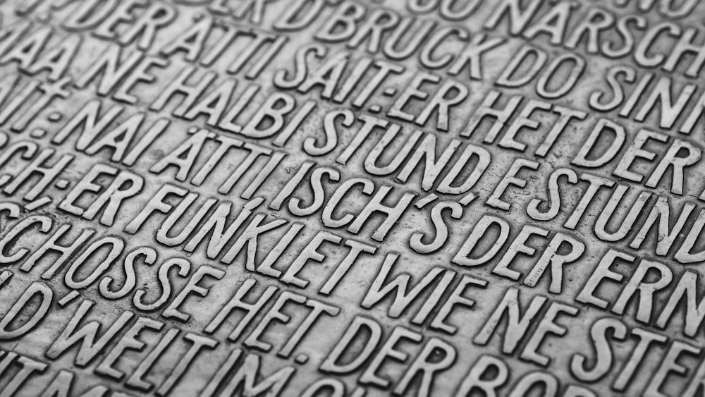 a close up of a metal surface with words on it