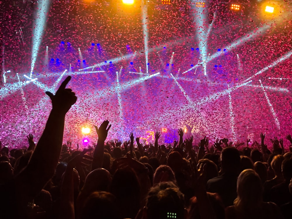 crowd raising their hands