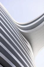 a curved building with a sky background