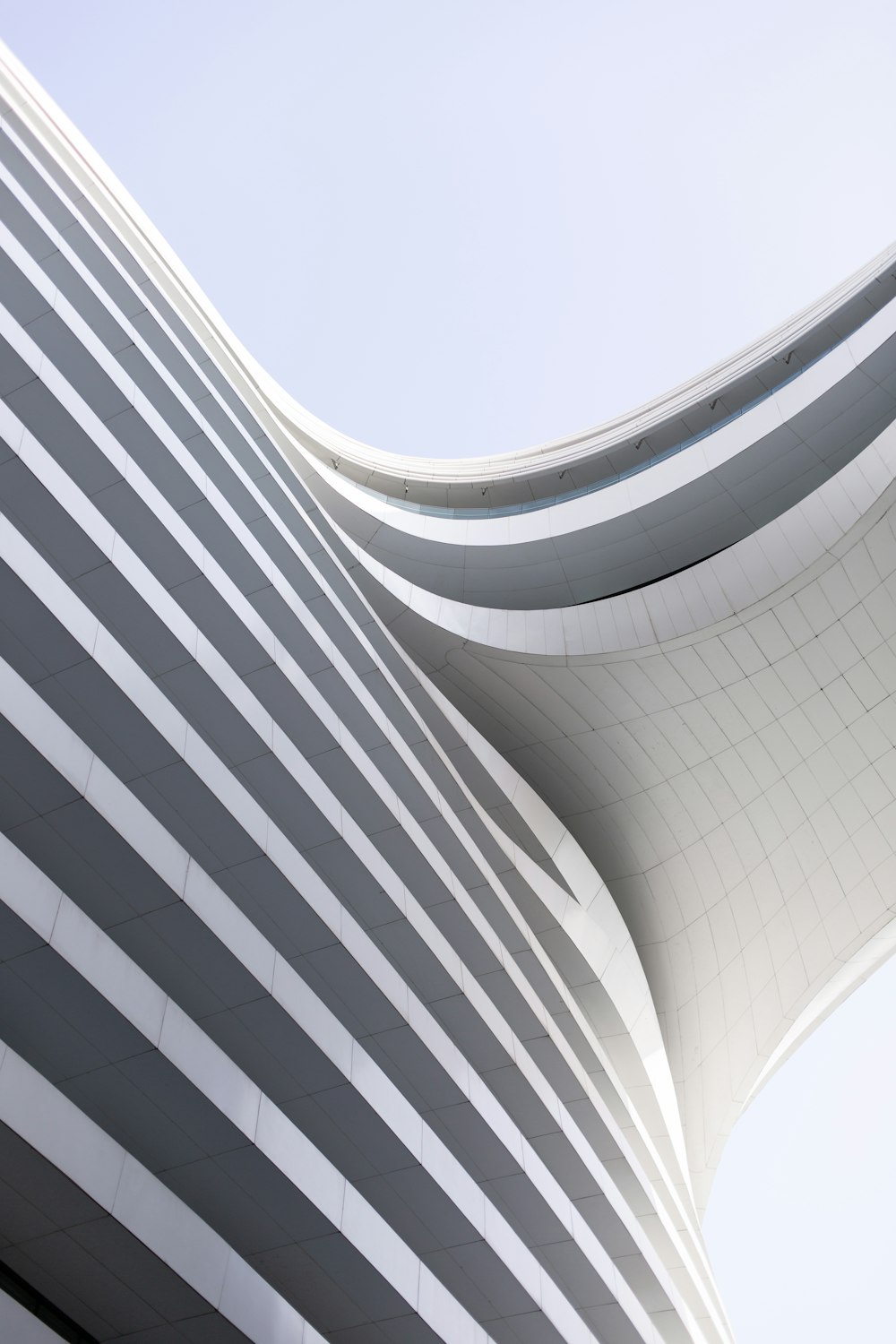 a curved building with a sky background