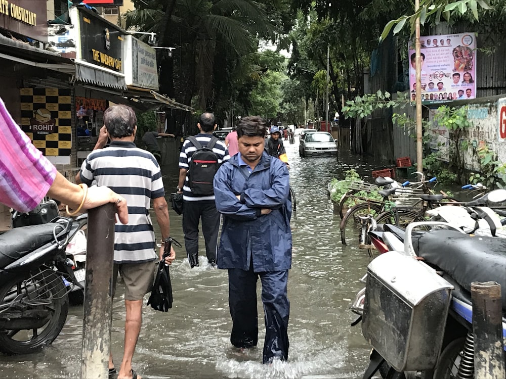 people walking on flooded streets during day