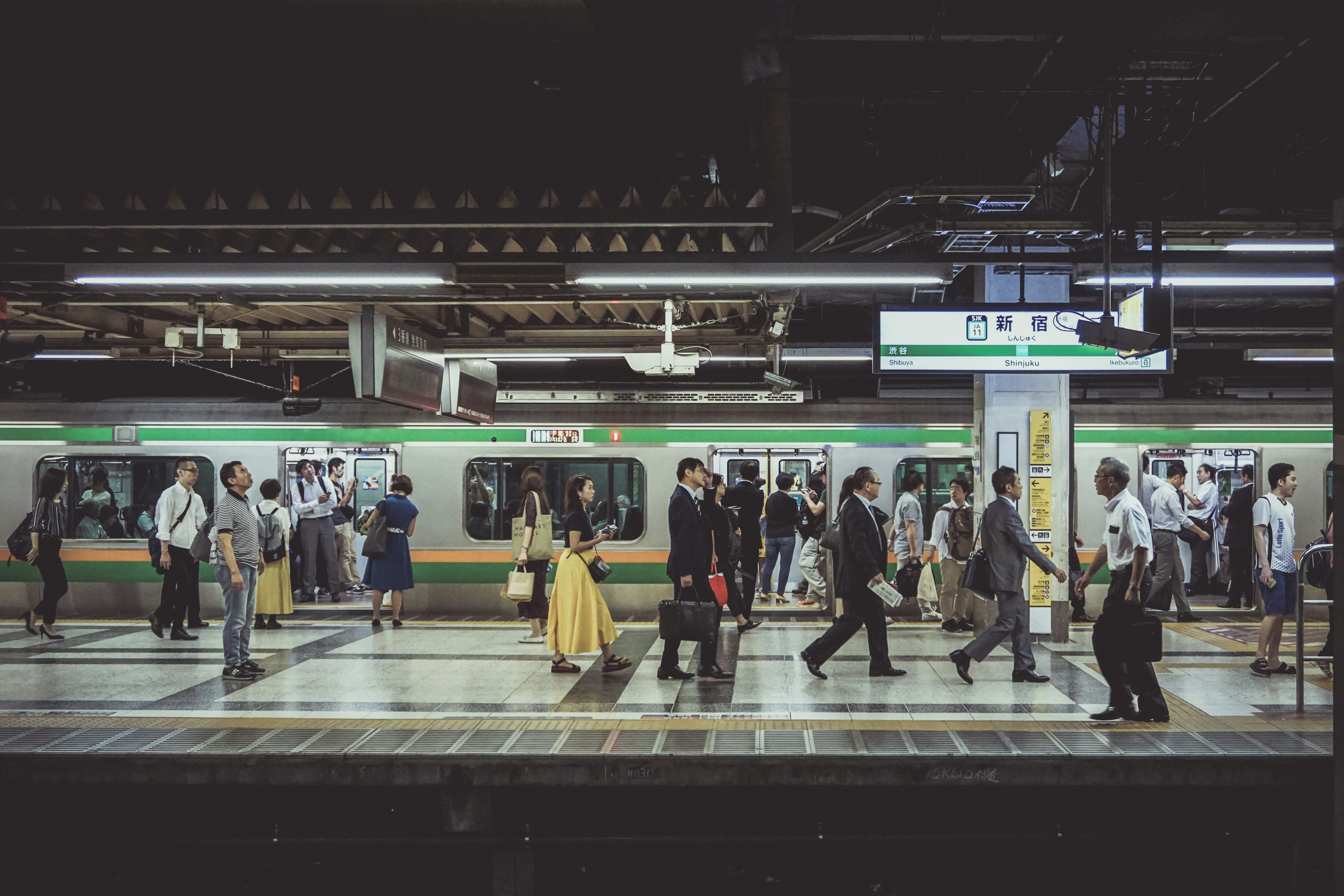 people standing and walking in train station