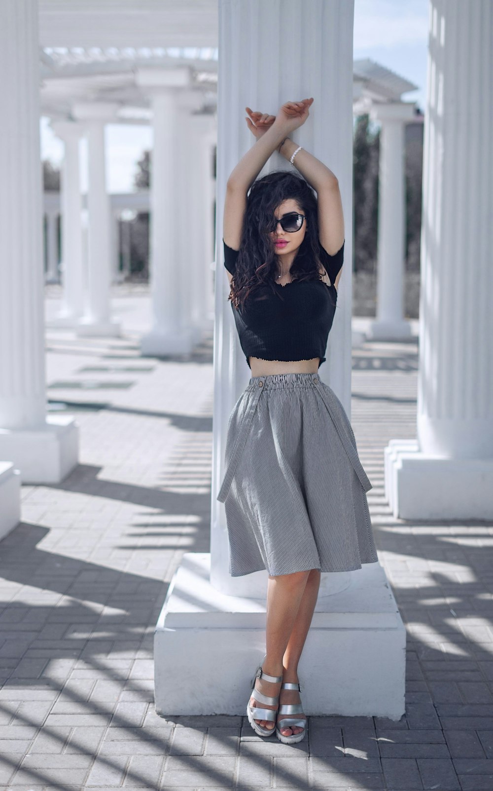 woman leaning on pillar