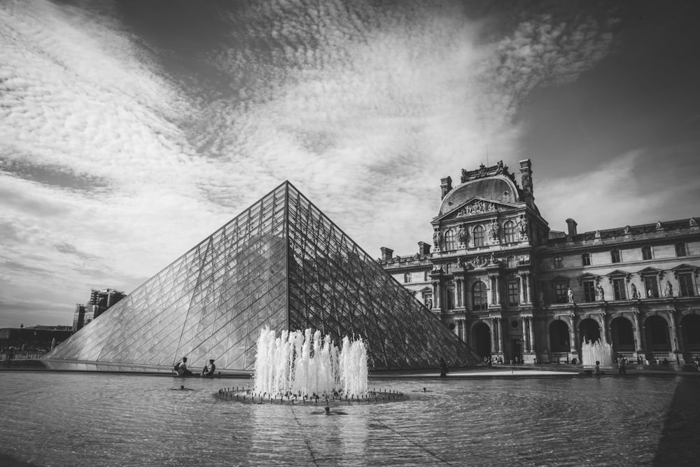 grayscale photo of waterfalls and building