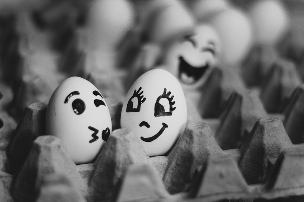 grayscale photography of two eggs on tray
