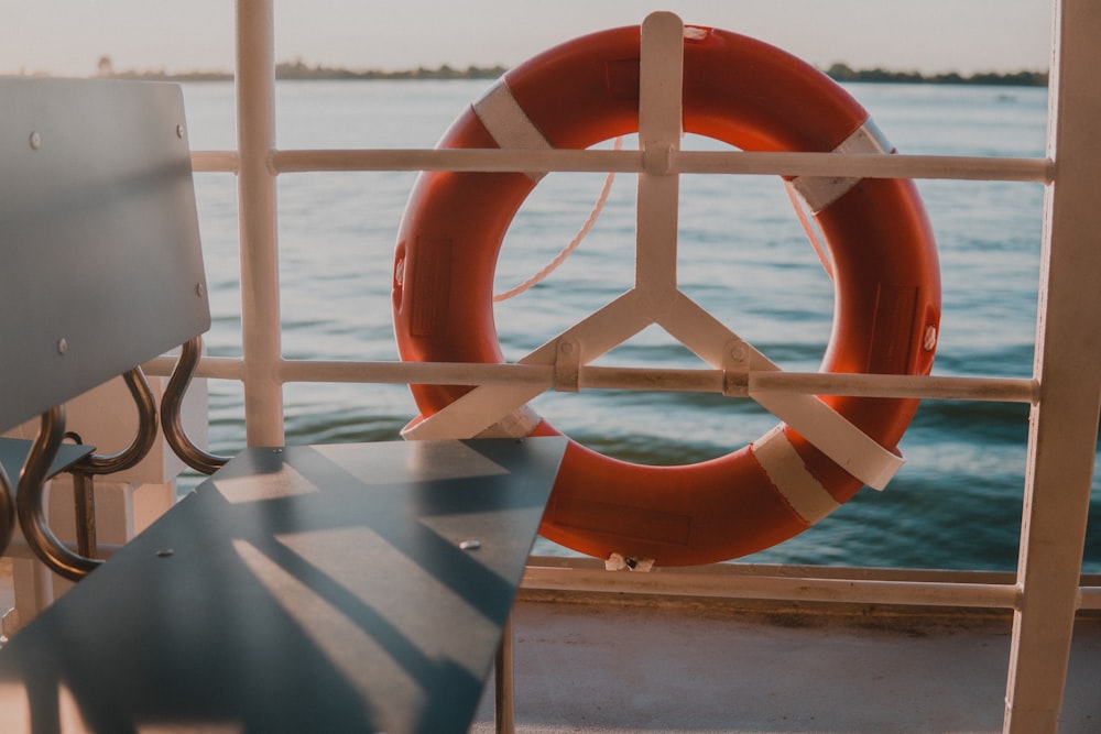 empty gray chair beside boat rail