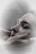 A close-up of a person with closed eyes, being gently cradled by hands which suggest a comforting or soothing gesture. The soft focus and muted colors create a calm, serene atmosphere.