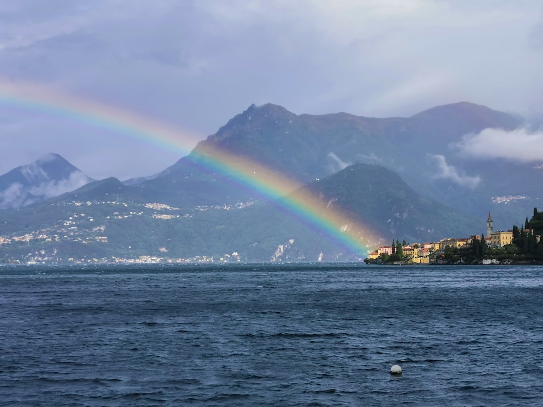 rainbow over a mountain and blue sea