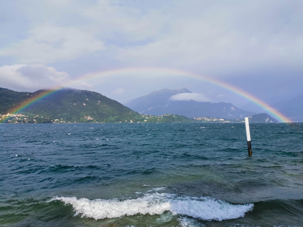 blue beach under rainbow