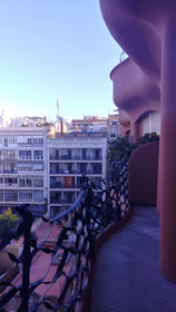 Modern metal balcony railing with a scenic city view in the background.