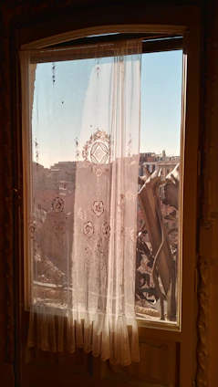 Metal curtain rings hanging on a stylish rod with linen sheer curtains flowing