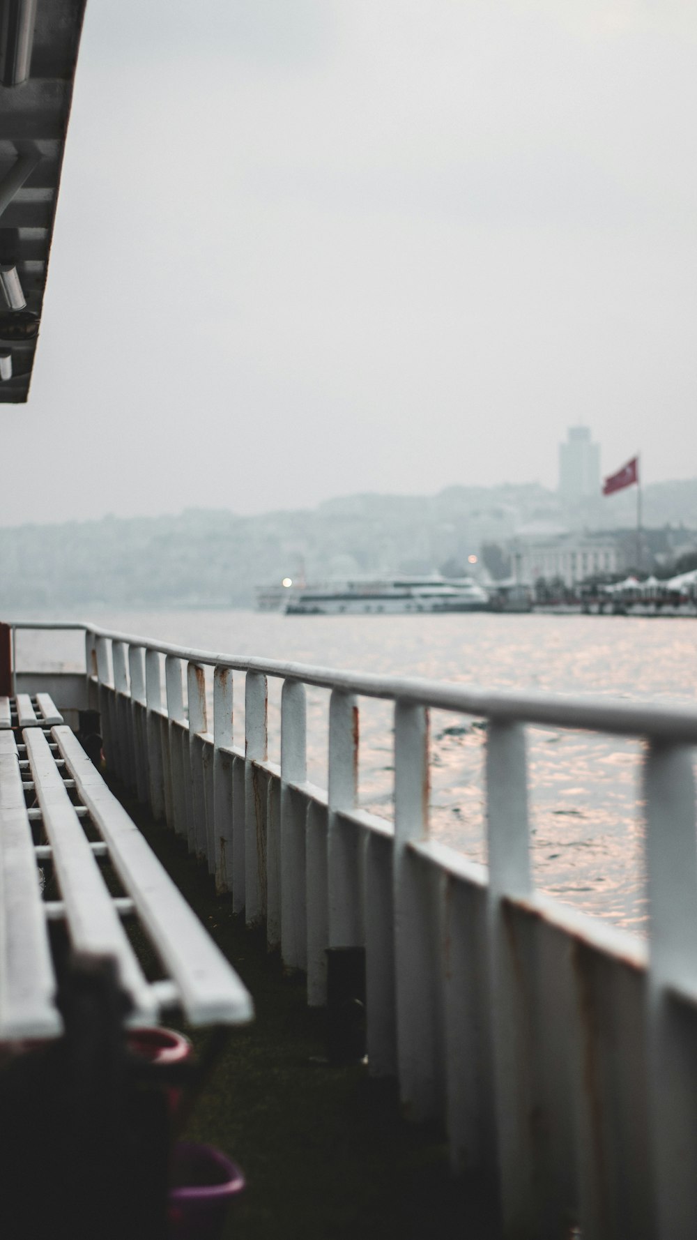 a row of benches sitting next to a body of water