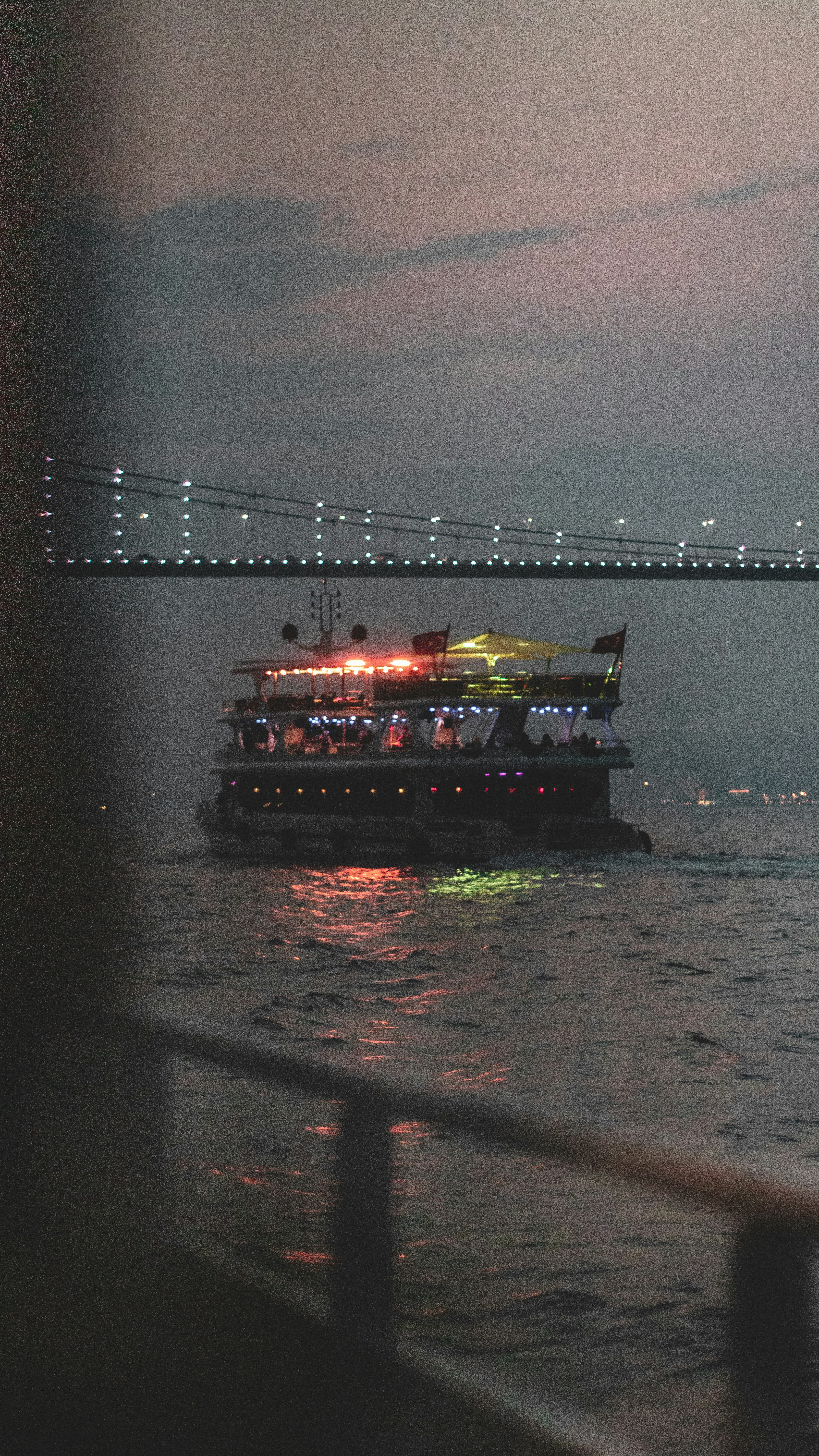 cruise ship under bridge