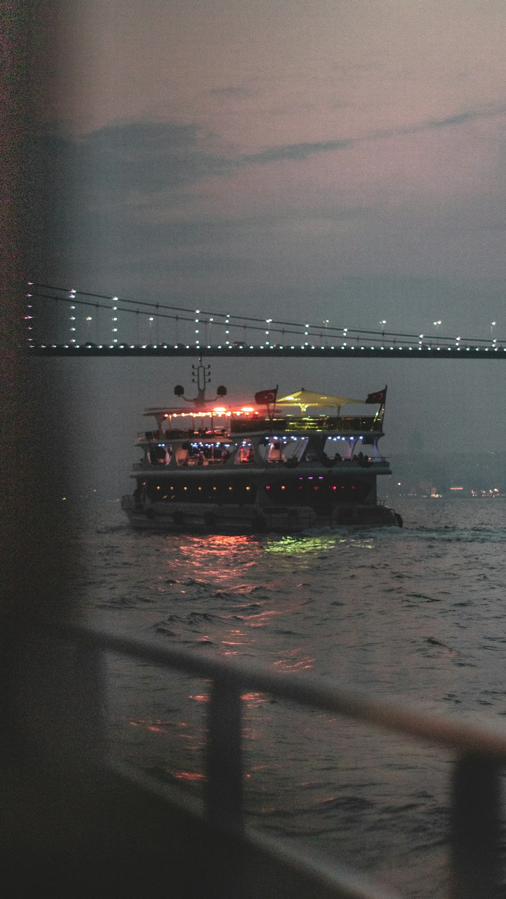 cruise ship under bridge