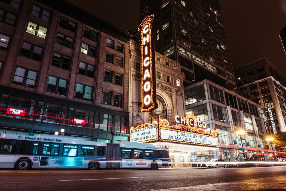 bus on road beside building during nighttime