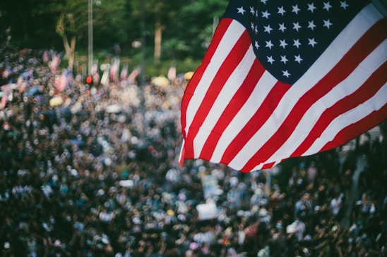 A vibrant gathering of Trump supporters holding American flags at a community event.
