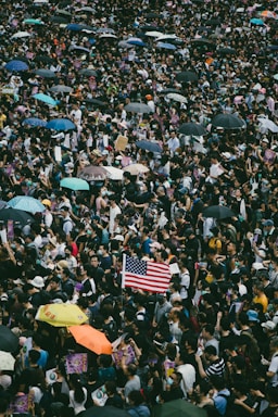 street photography,how to photograph tens of thousands of protesters waving us flags marched on hong kong's us consulate to call for help from the trump administration in ending a three-month confrontation with the government, calling for the passing of the proposed "hong kong human rights and democracy act 2019" by the us congress - 8th september 2019; usa flag held by people