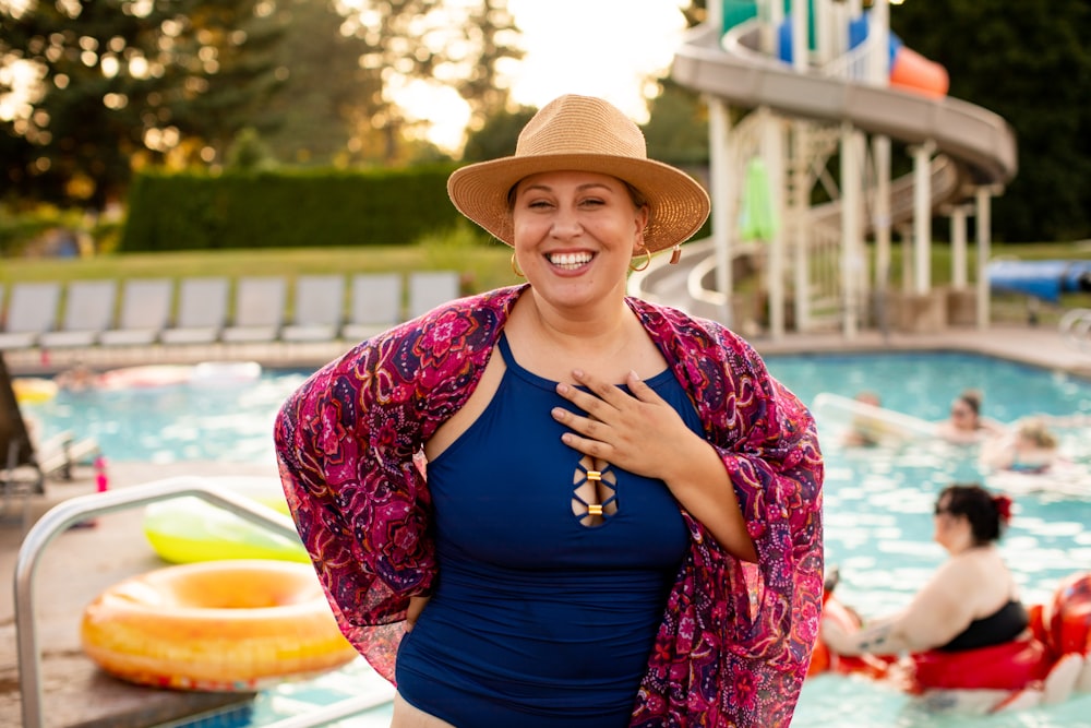 mulher no top azul da alça do espaguete usando o chapéu