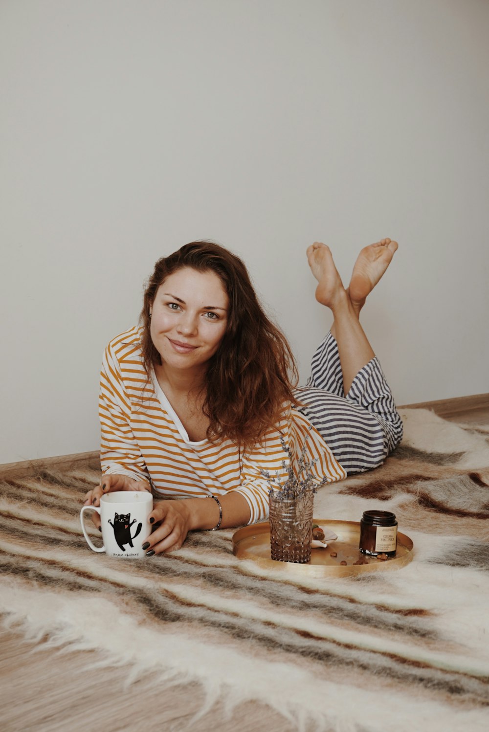 shallow focus photo of woman in brown and white striped long-sleeved shirt