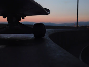 Close-up of colorful skateboard wheels spinning on pavement.
