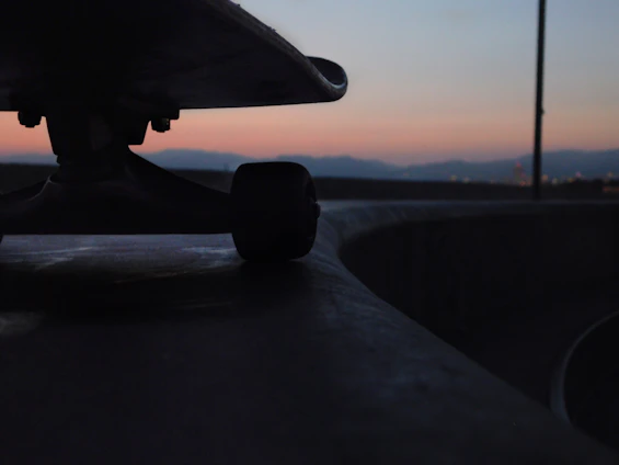 Close-up of a skateboard bearing spinning rapidly under bright urban lights.