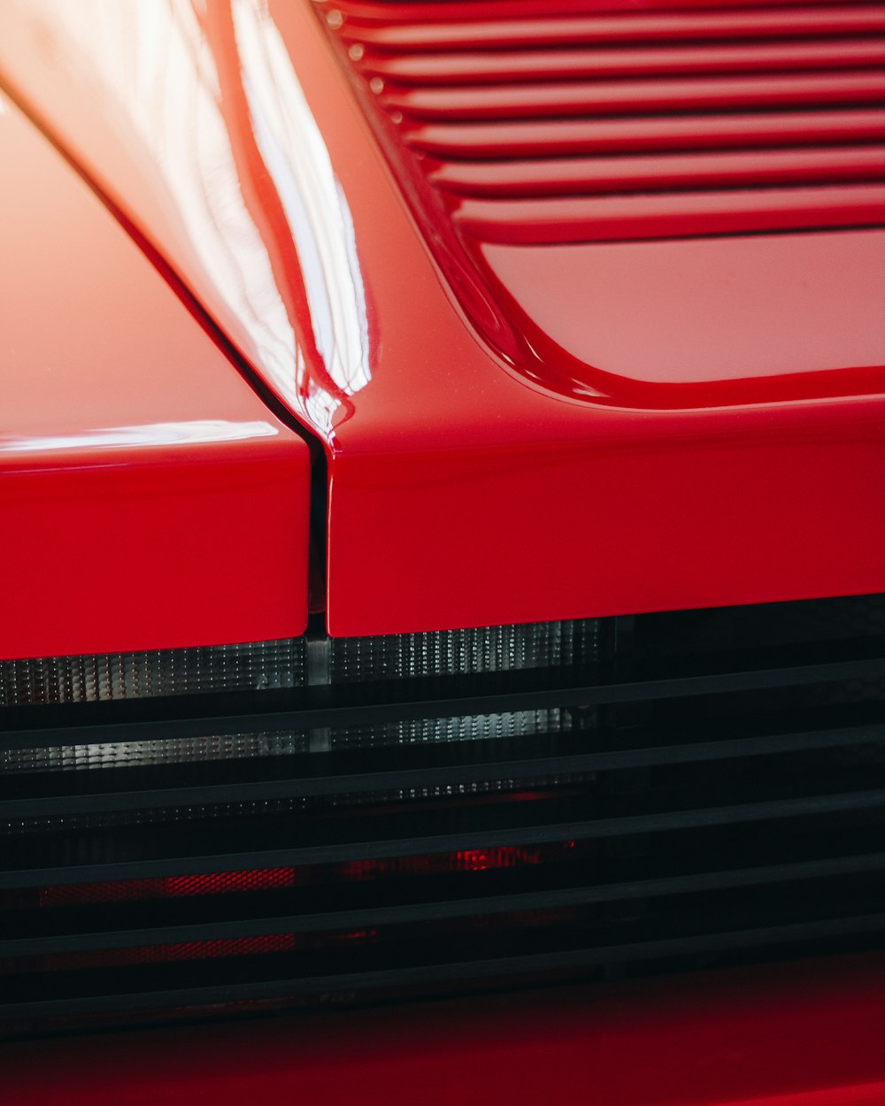 the front end of a red sports car