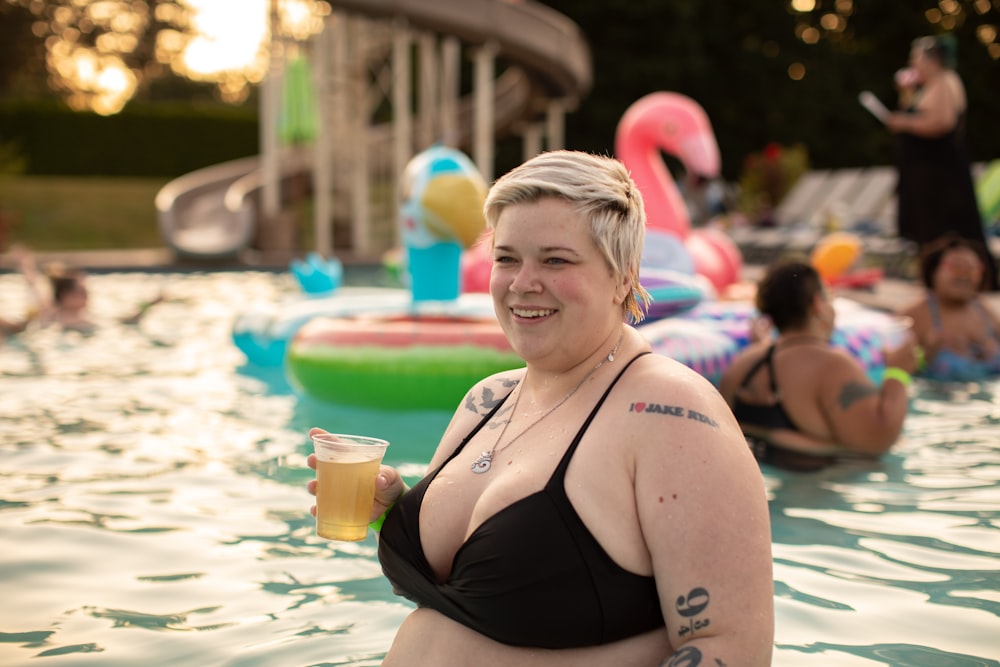 woman wearing black bikini top on body of water