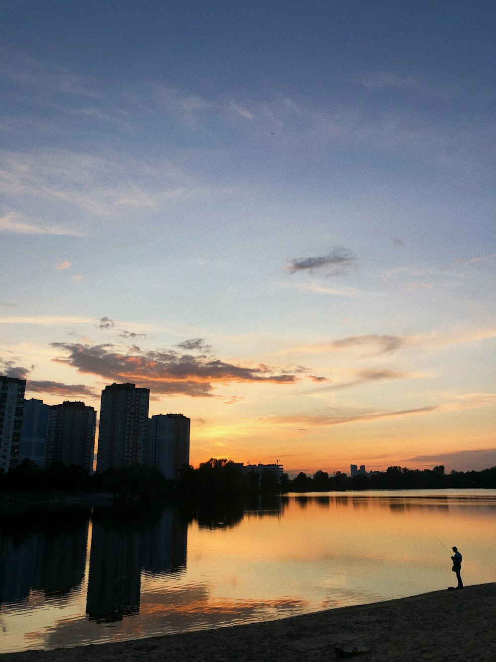 man standing near body of water