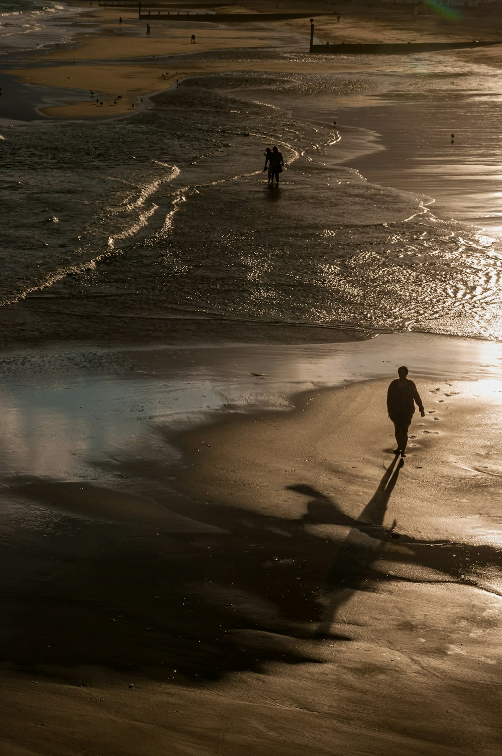 person standing on seashore during daytime \