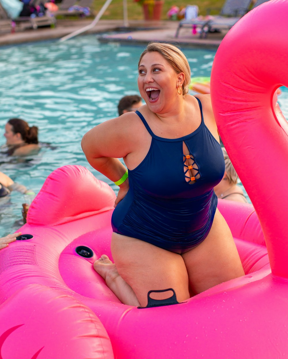 woman on pink flamingo float