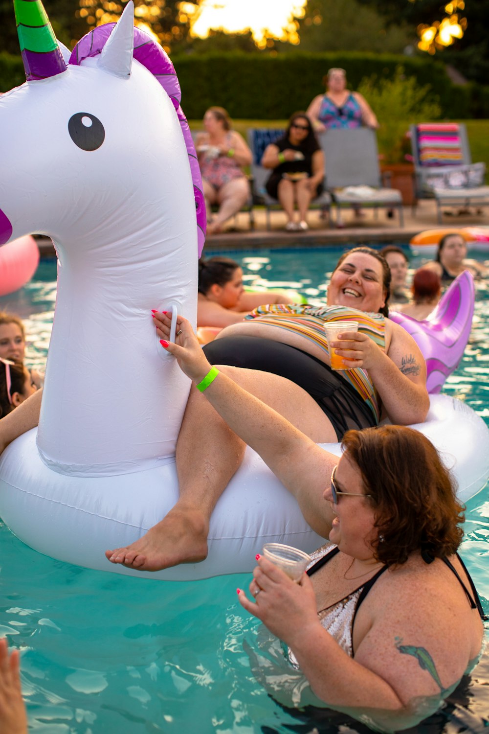 woman lying on unicorn floater