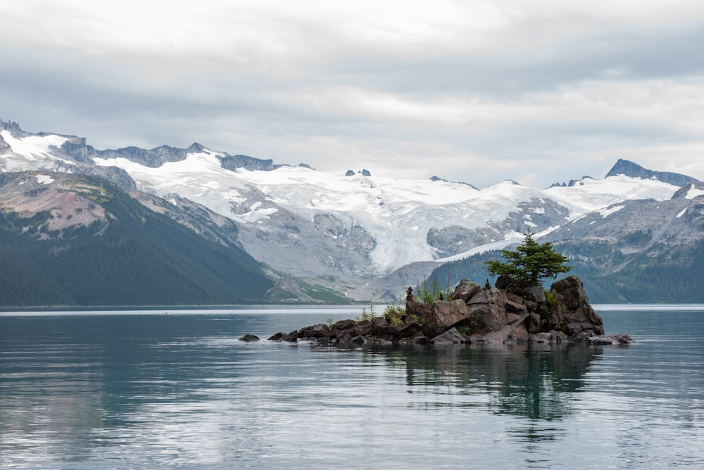 gray stone islet across white mountain