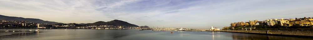 a body of water with a city in the background