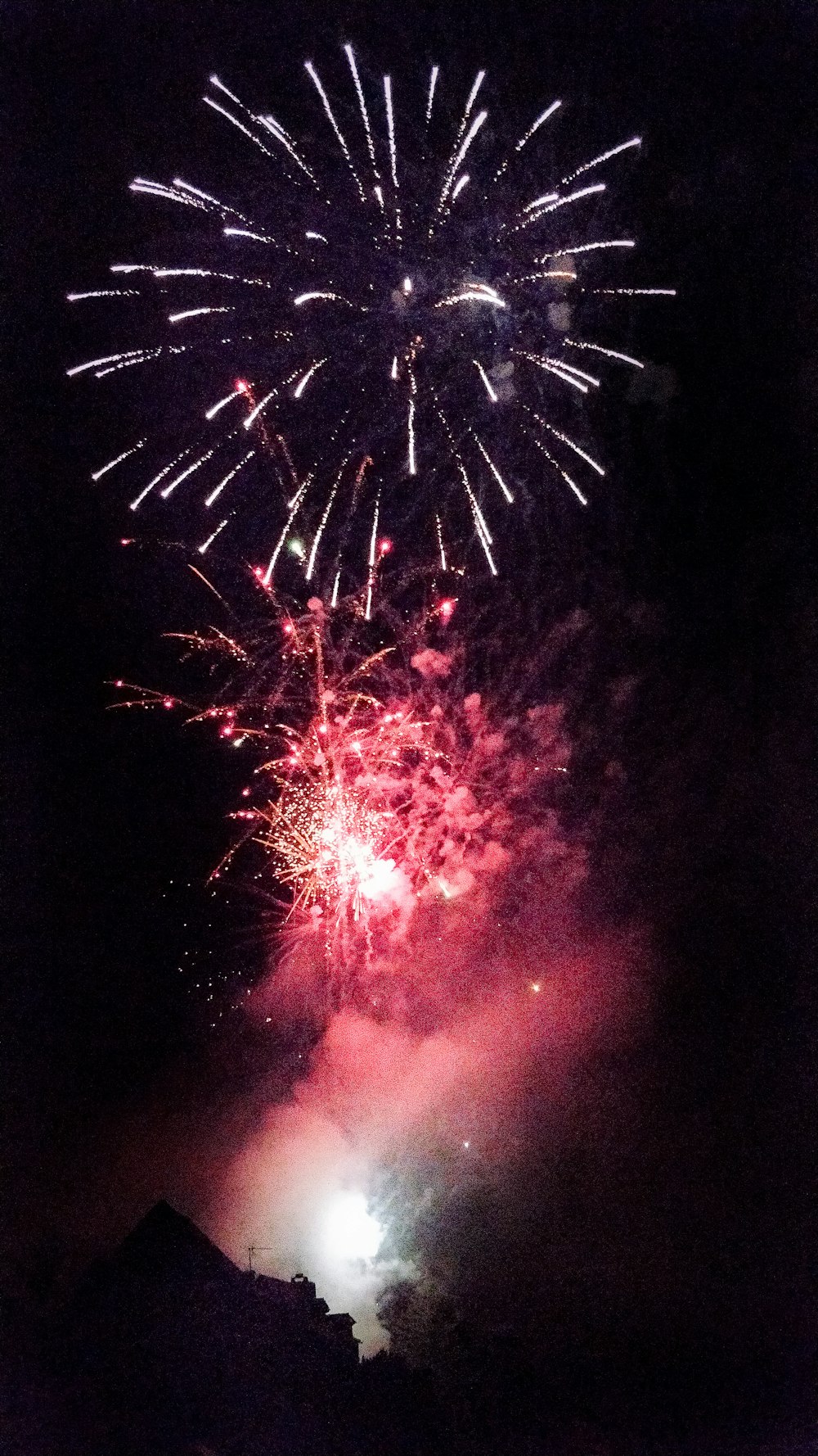 long-exposure photography of red and white fireworks