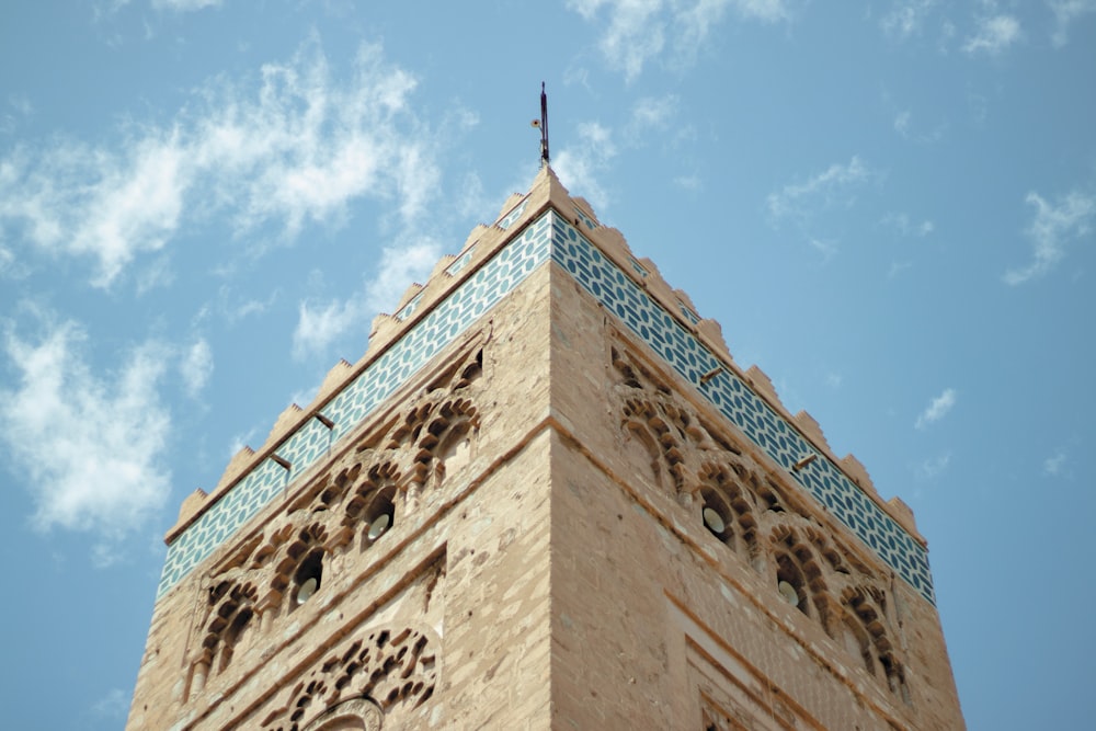 low-angle photography of brown concrete building under calm blue sky