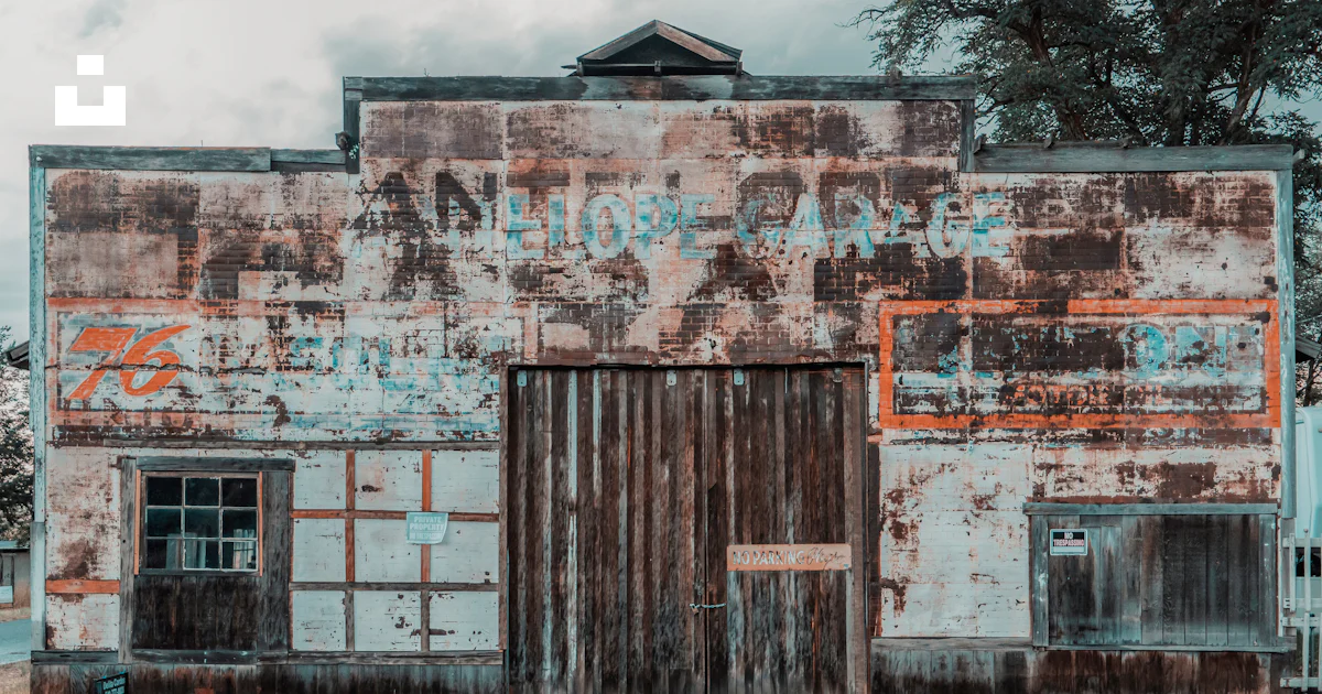 An old rusted building with a wooden door photo – Free Oregon Image on ...