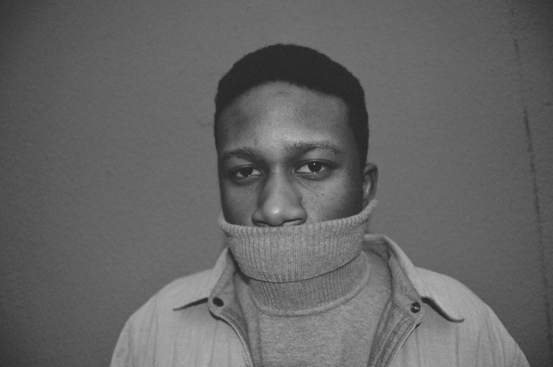 grayscale photography of man wearing turtleneck sweater