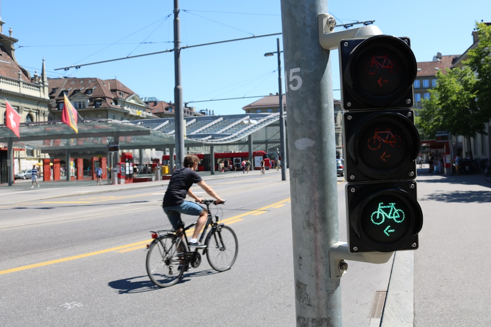 man riding bicycle on road during daytime