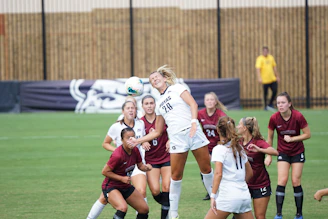 A skilled female player controlling the ball with precision during a women's league match.