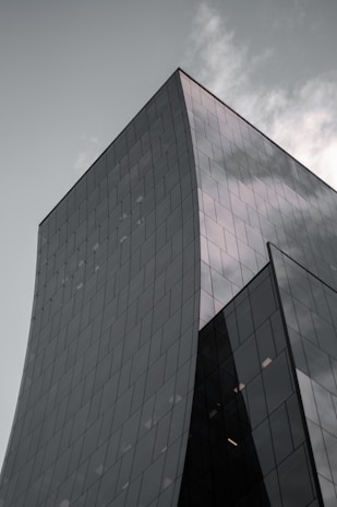 A sleek modern building with clean lines and glass facades reflecting the sky.