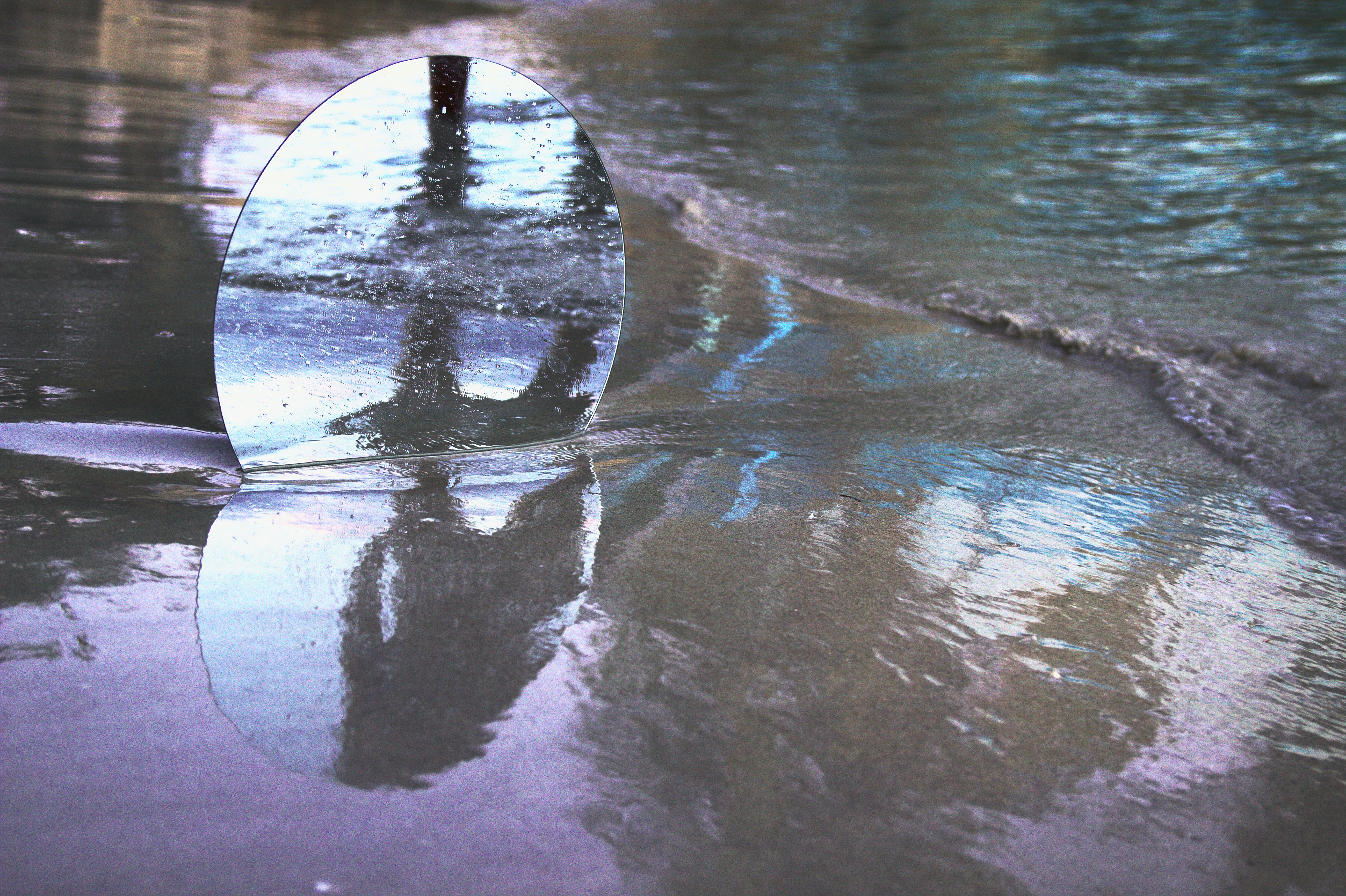 round mirror on sand