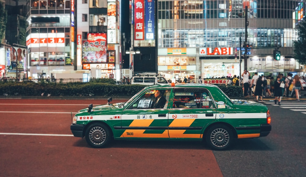 green taxi on road