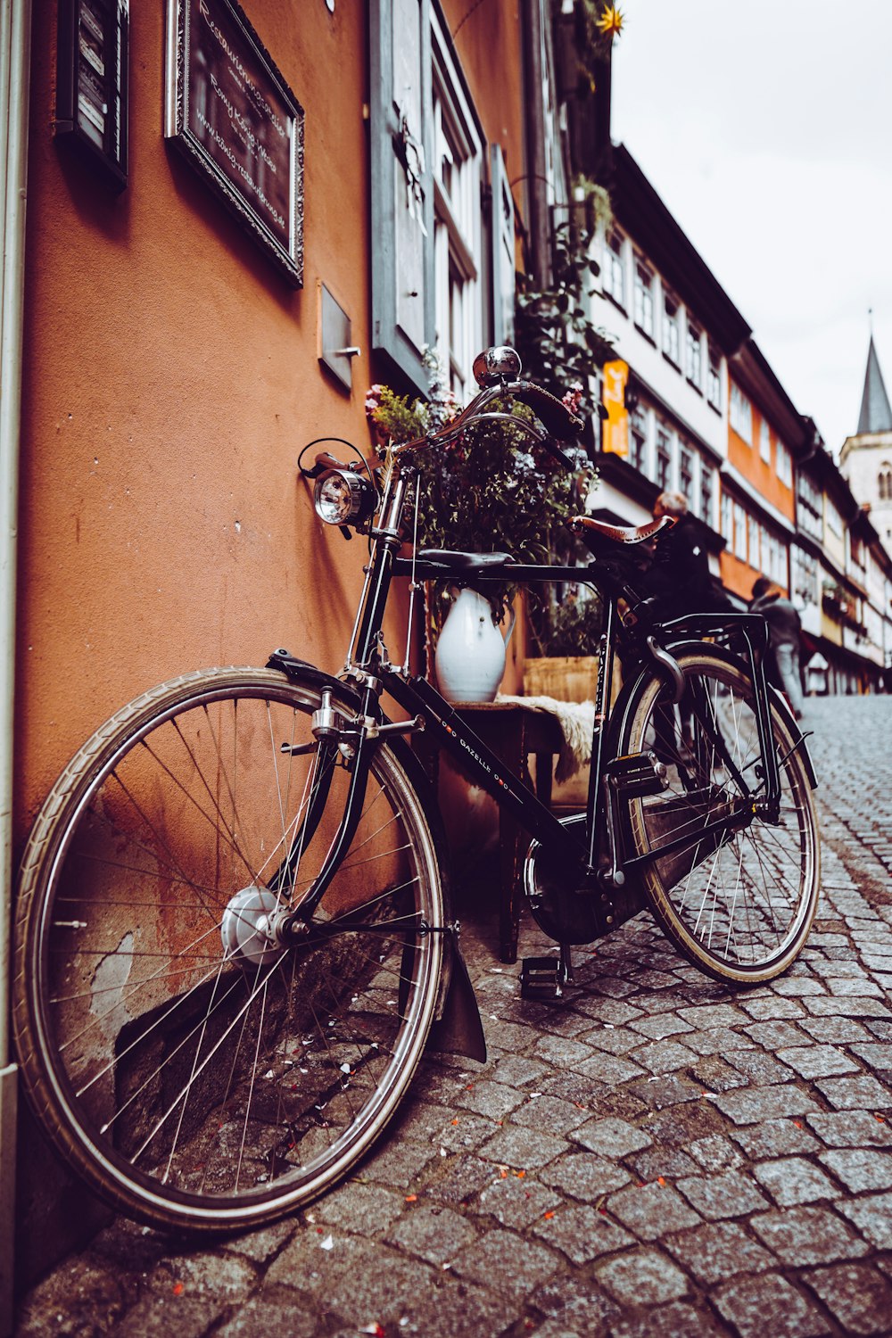 black bicycle parked outside a house