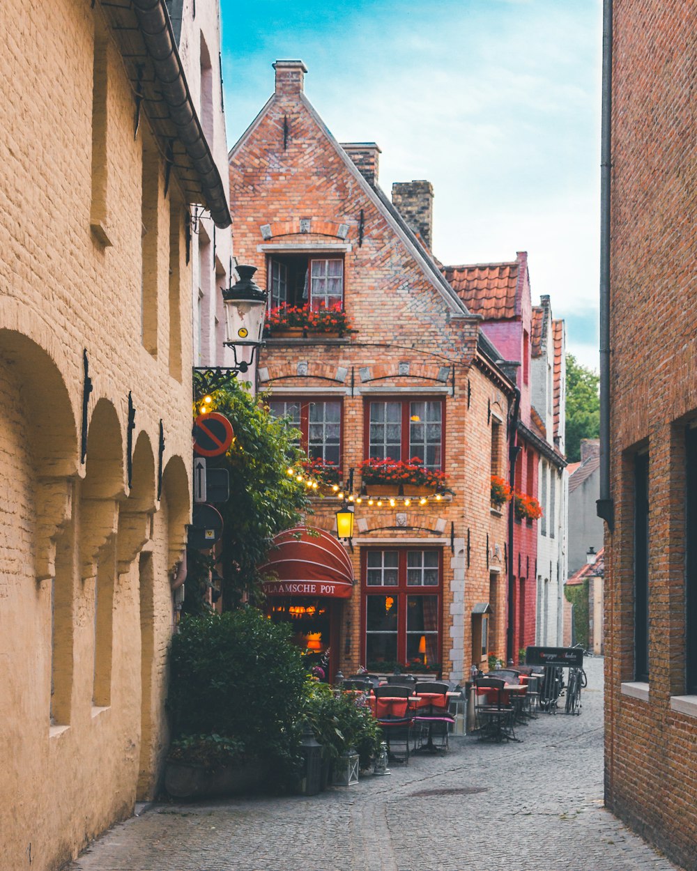 a cobblestone street lined with brick buildings