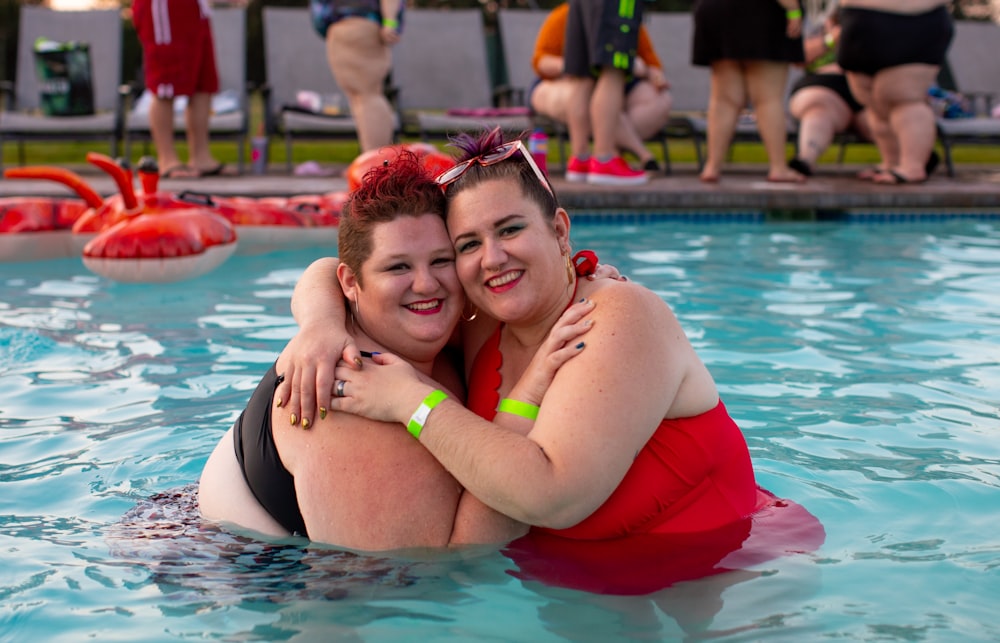 two women wearing red and black swimsuits