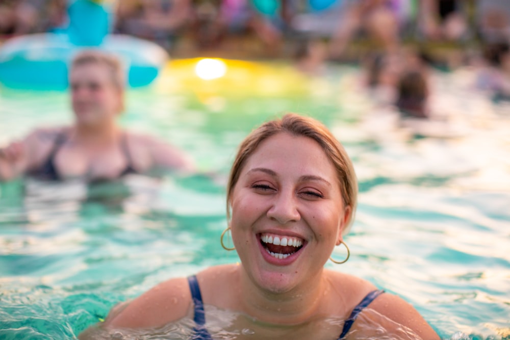 focus photography of woman swimming on pool