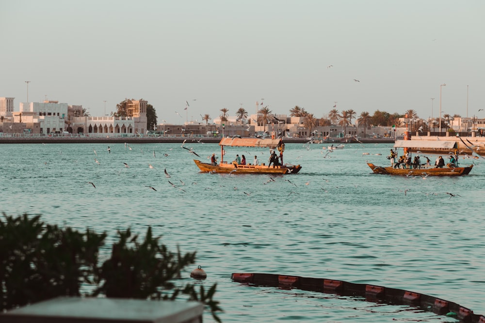 people on boat near buildings at daytime