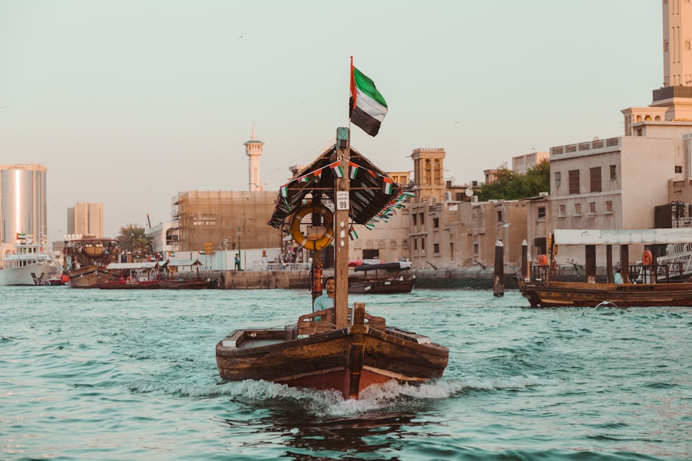 boat with flag in ocean