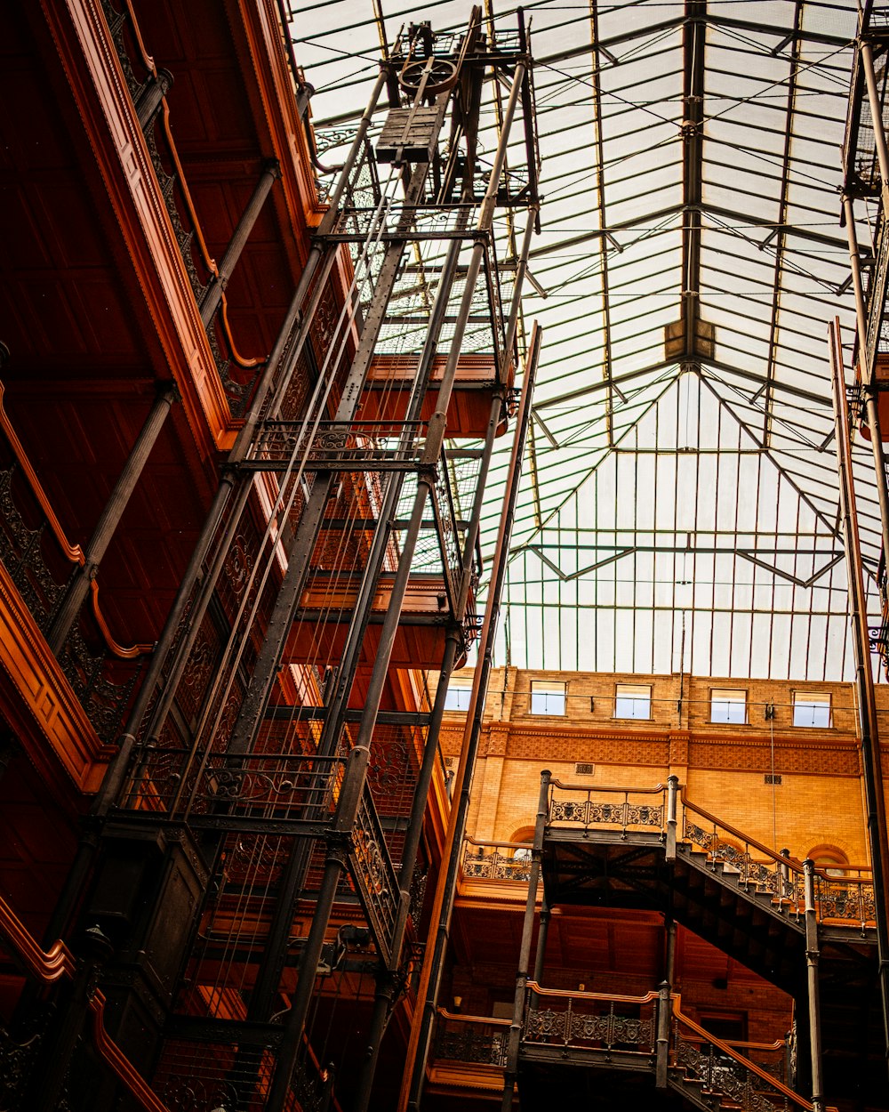 low angle photography of brown building interior with scaffolding